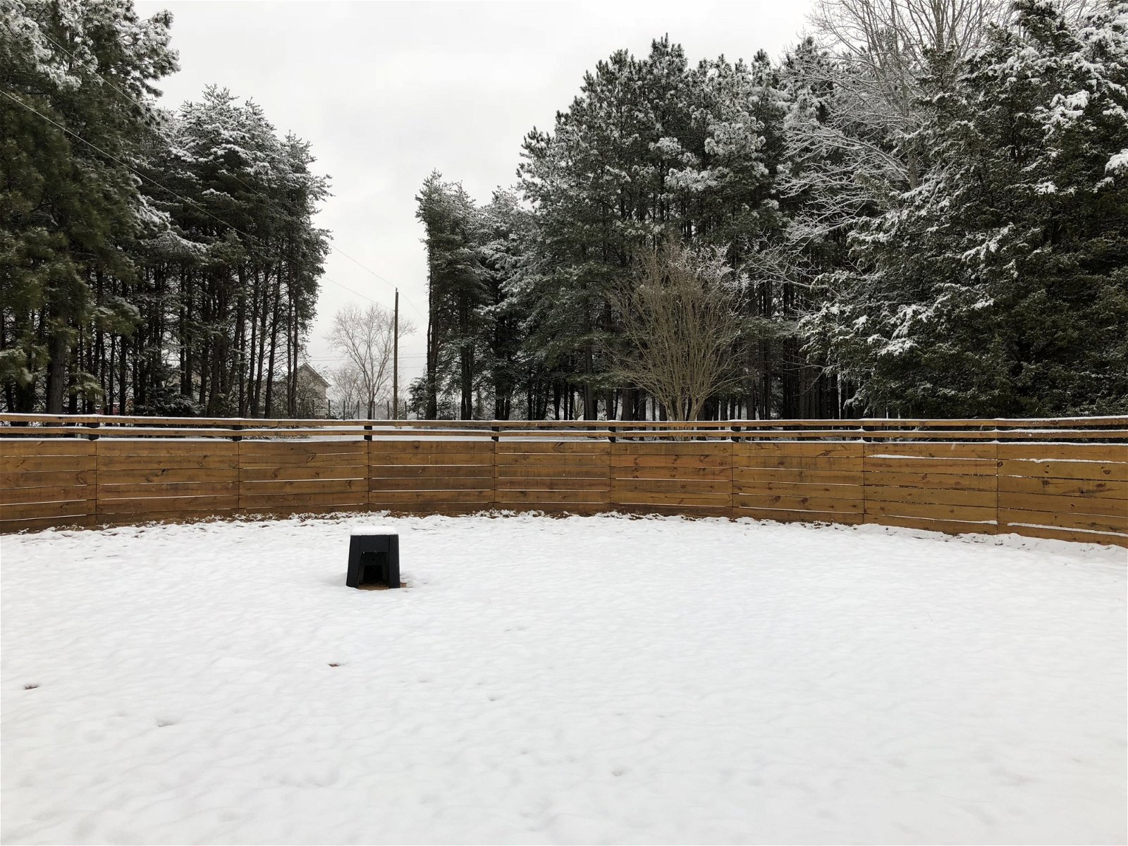 Round pen with a layer of snow