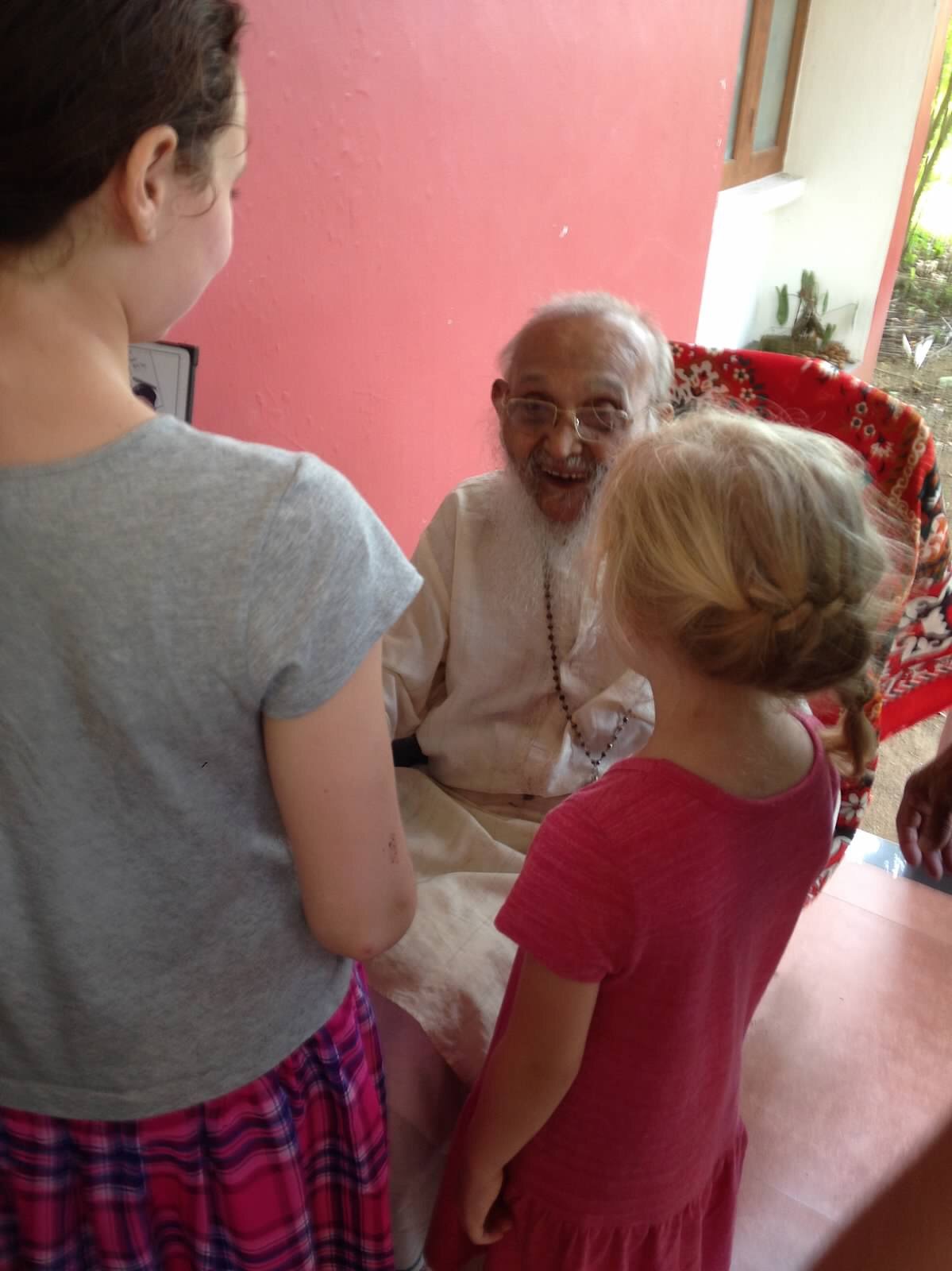 Girls talking with Indian Rev. Father