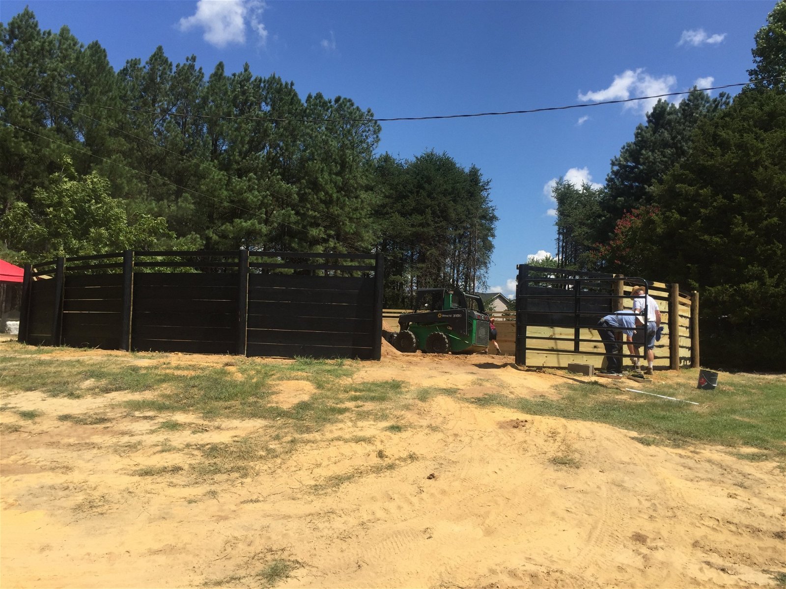 Round Pen under construction with equipment and workers present