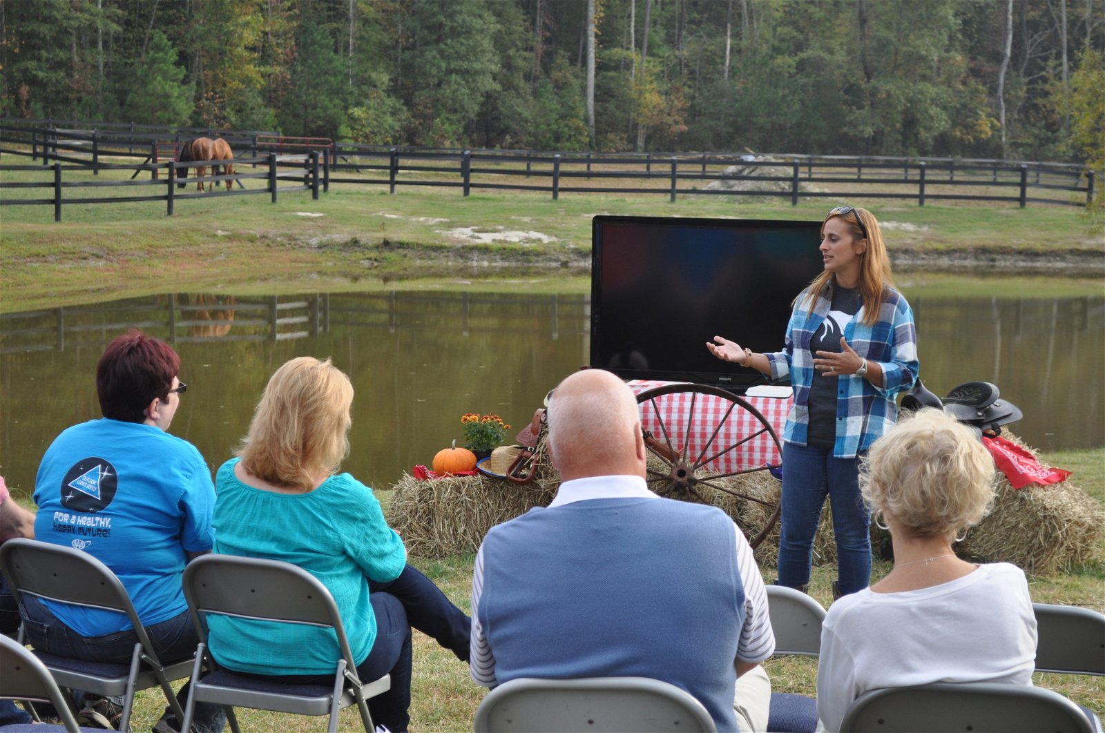 Woman presenting to a group at a farm